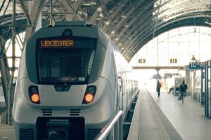 A train showing 'Leicester' on its ticker sign at a train station